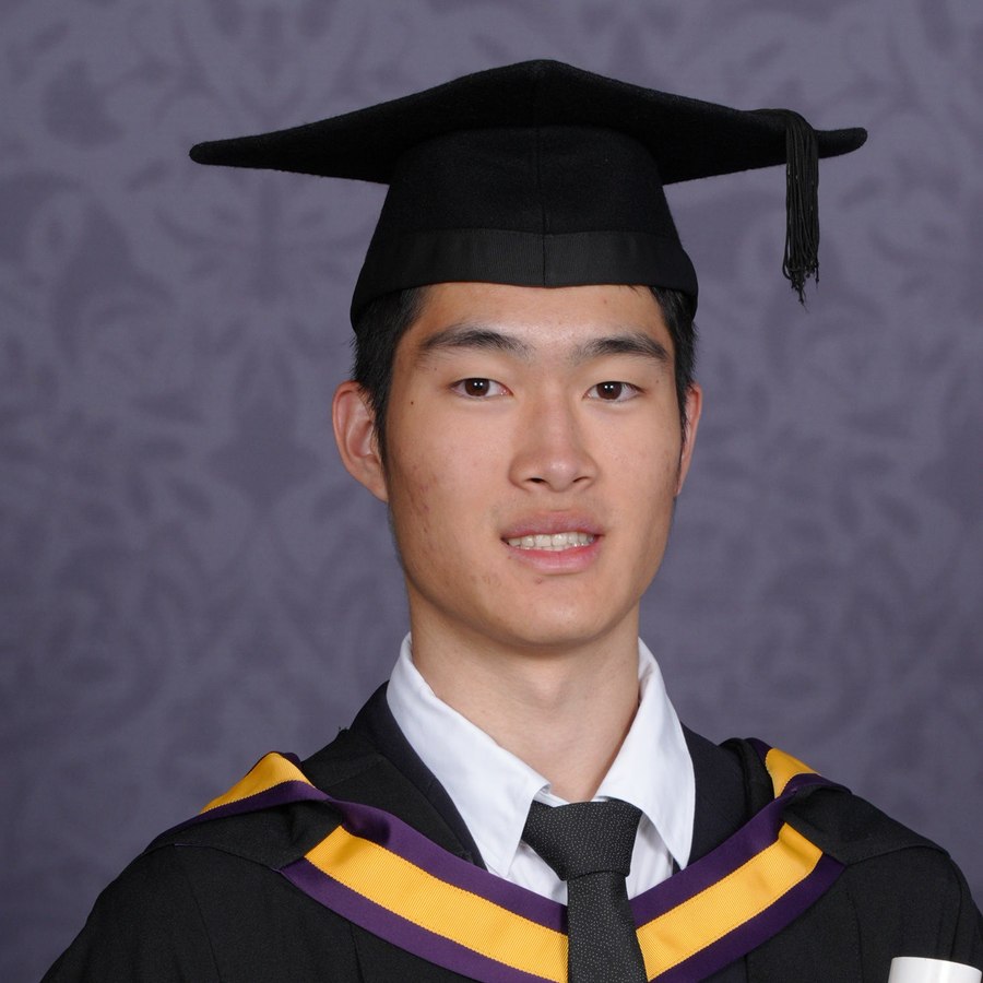 Charles Lin at graduation, wearing a mortarboard and gown